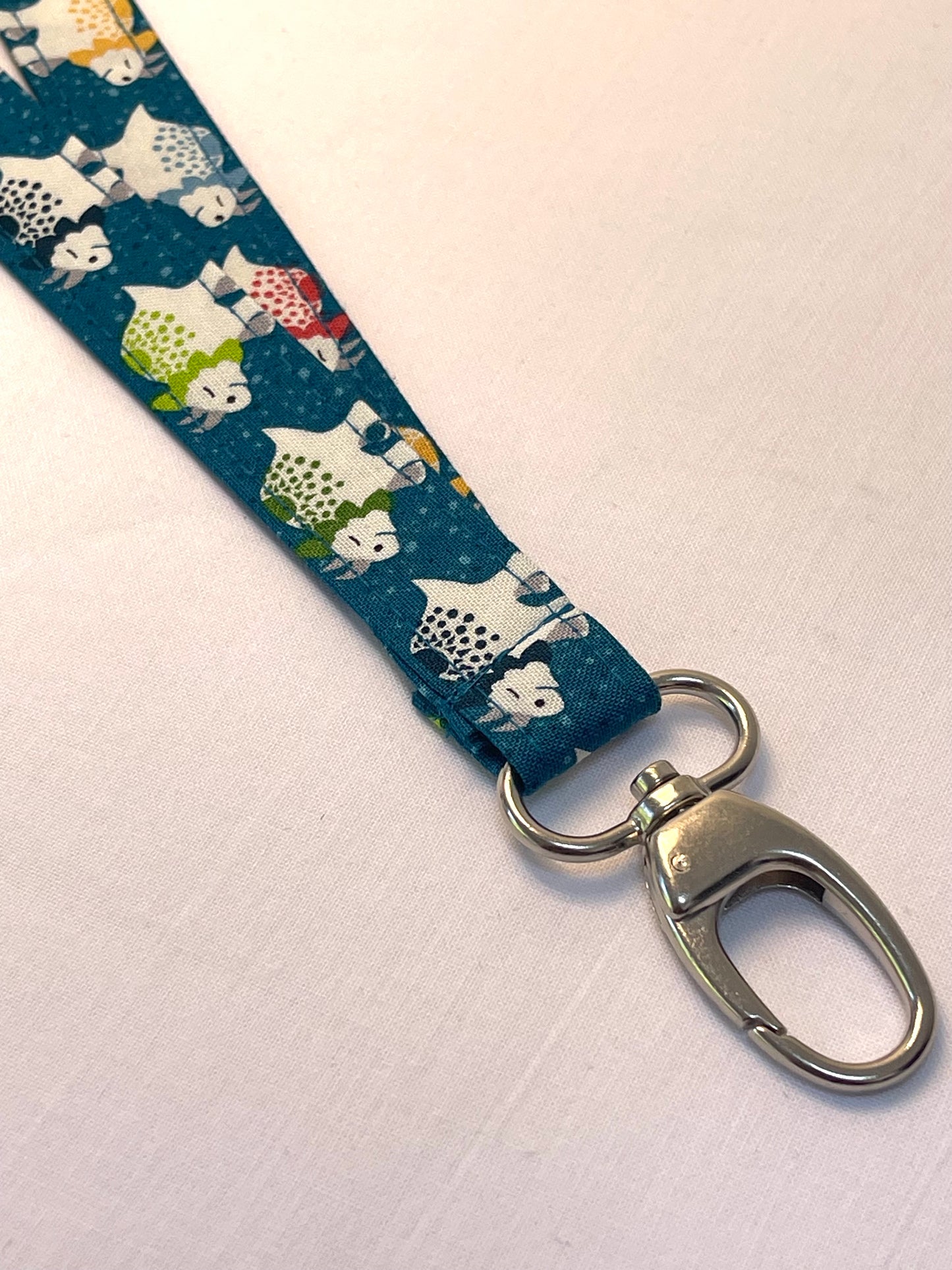 Fabric lanyard with animal pattern and metal clasp on a white background