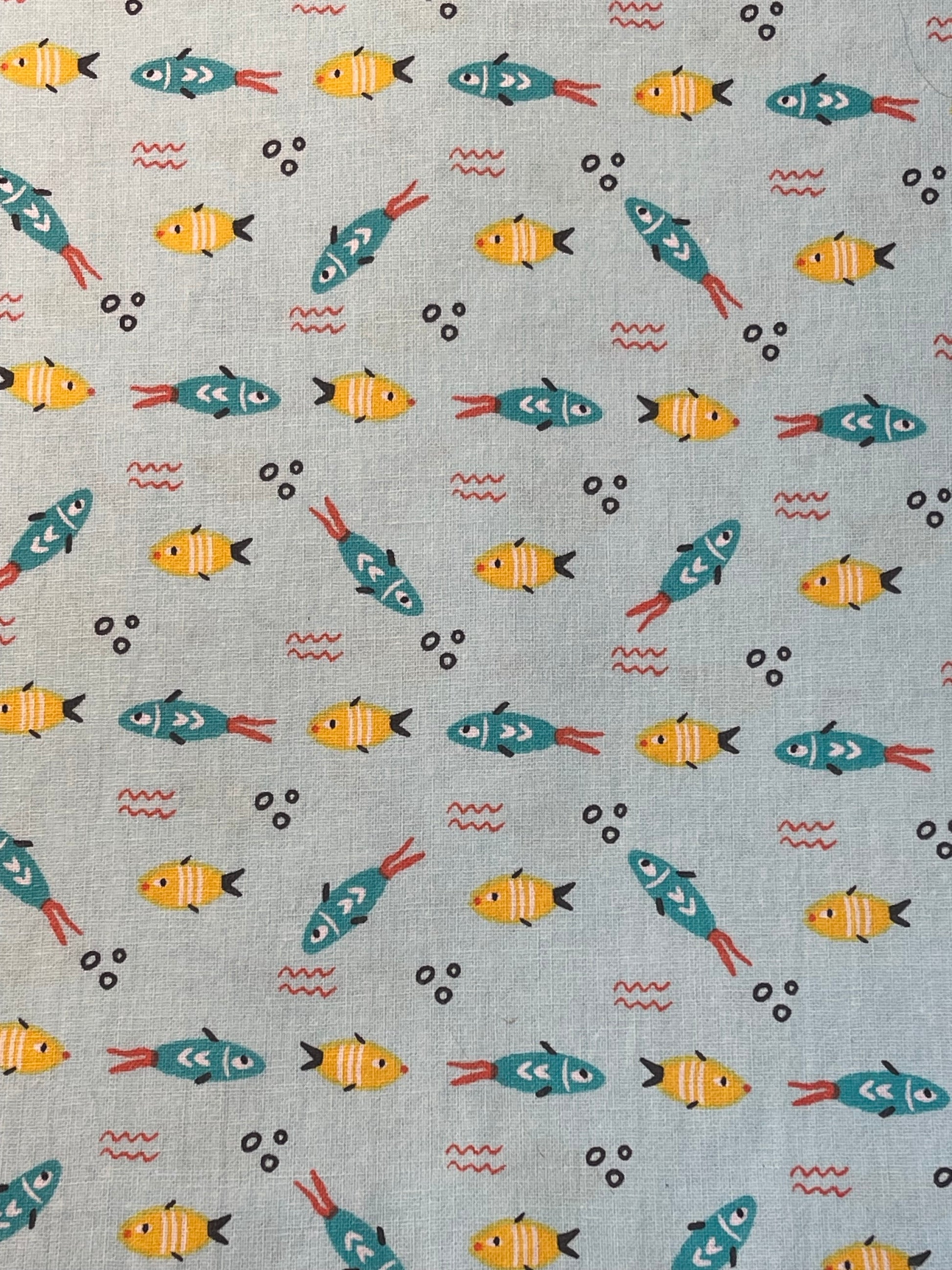 Pattern of colorful fish on a blue background