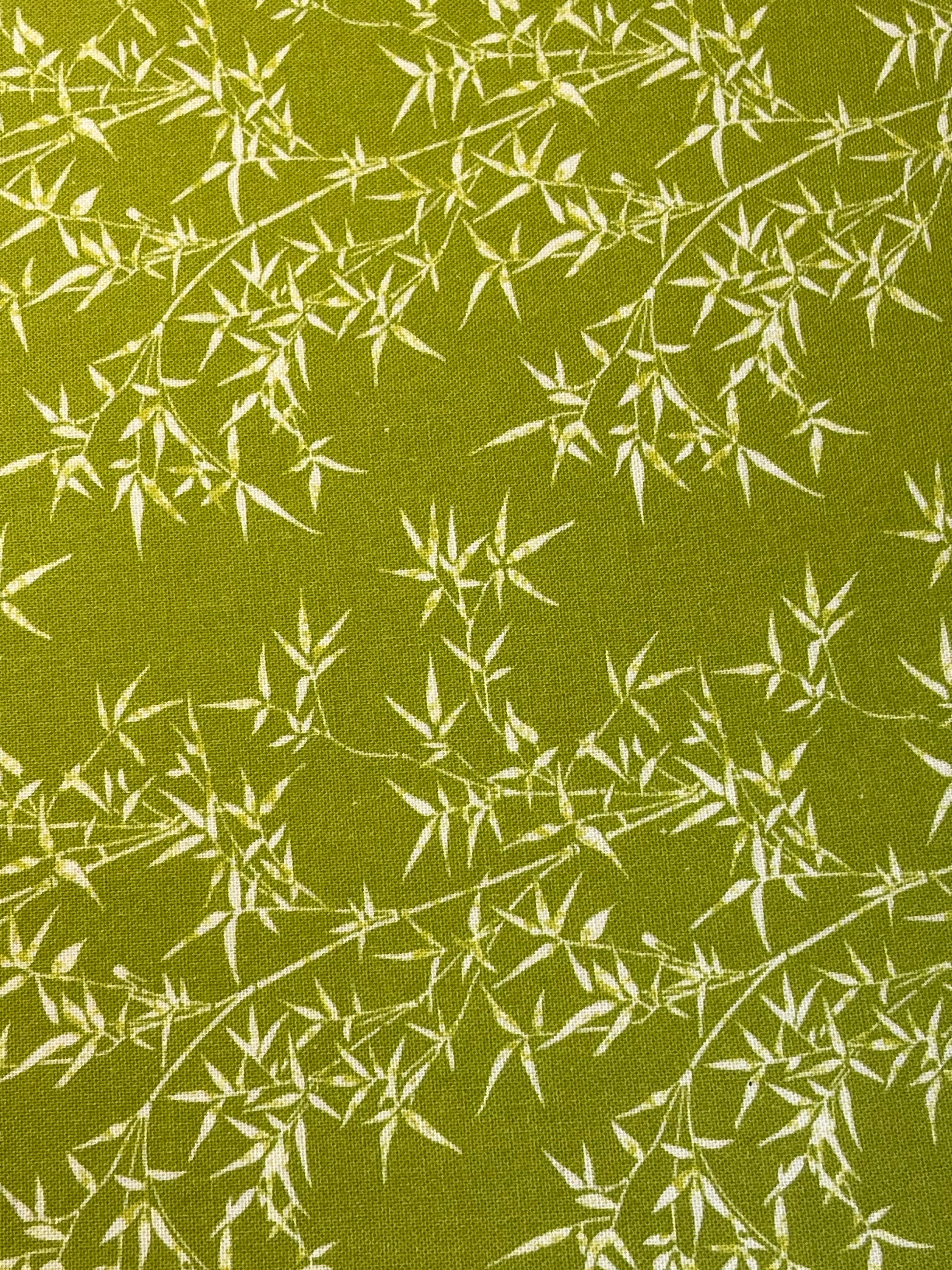 Fabric with white bamboo pattern on a green background