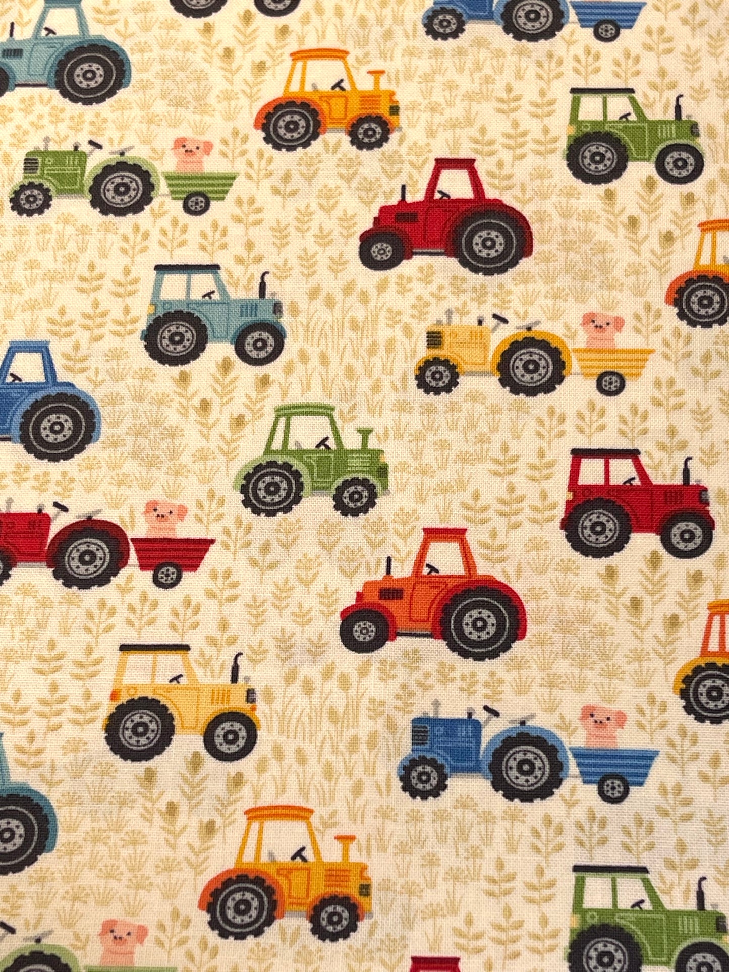 Pattern of colorful tractors and pigs on a beige background