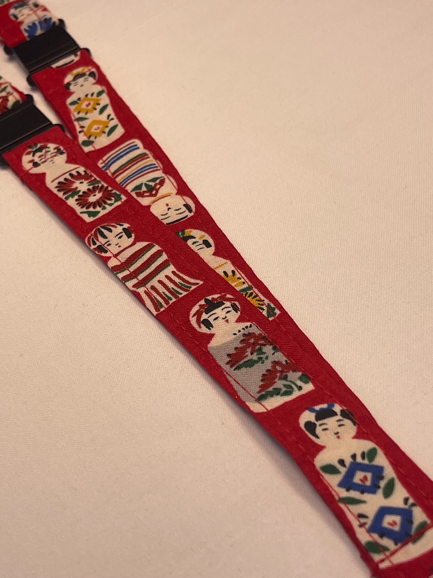 Red strap with decorative patterns on a beige background