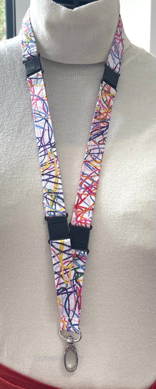 Colorful lanyard with a key ring on a mannequin wearing a gray sweater.