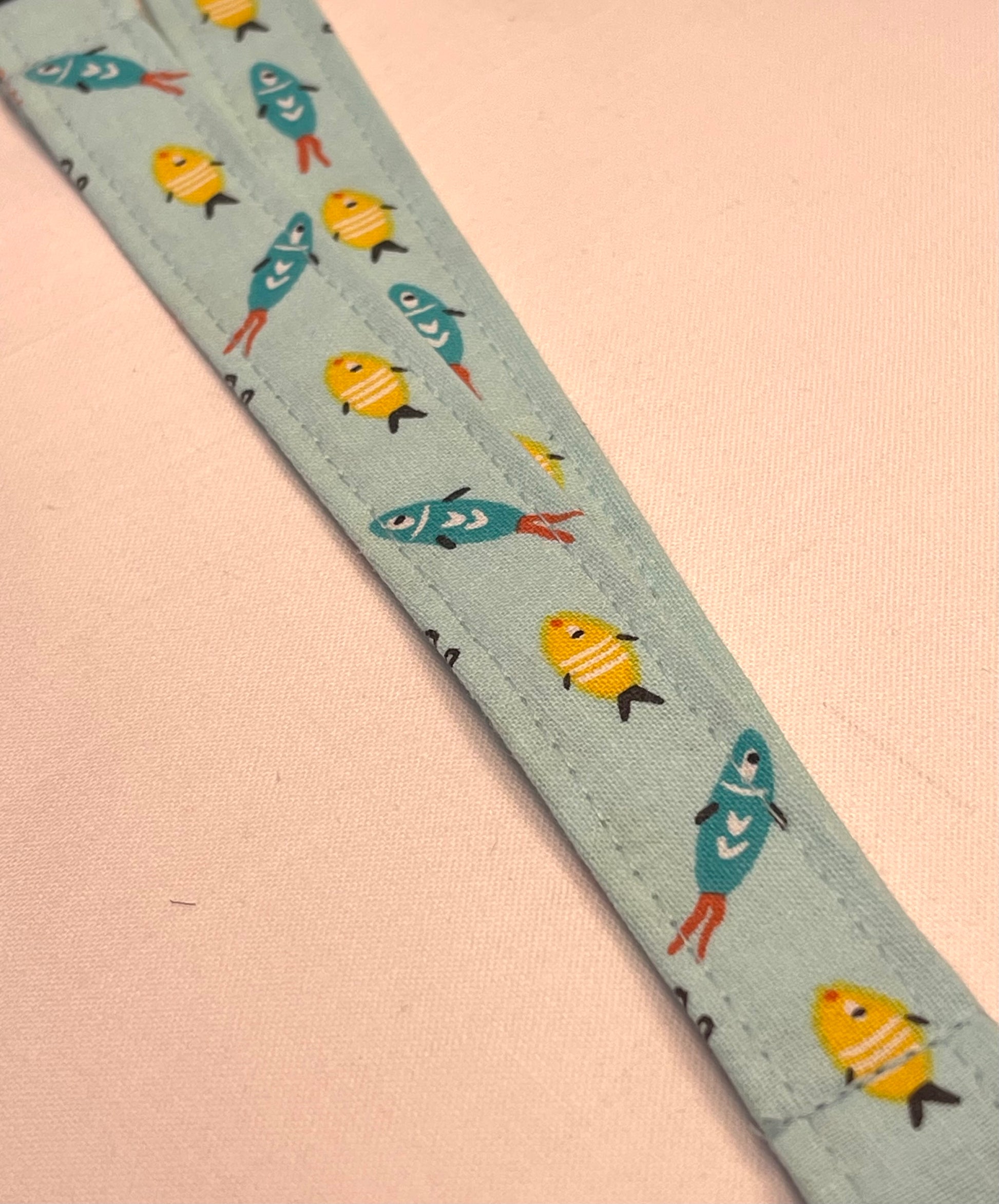 Fabric strip with fish pattern on a light blue background