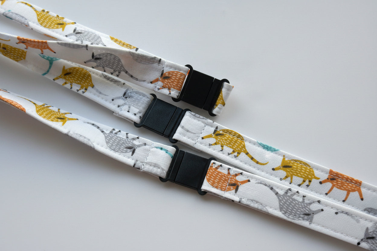 Handmade safety breakaway lanyard with multiple anti-strangulation breakaway points, designed for NHS, healthcare, mental health and security professionals. Close-up of plastic breakaway safety clip designed to release under pressure to reduce strangulation risk. 