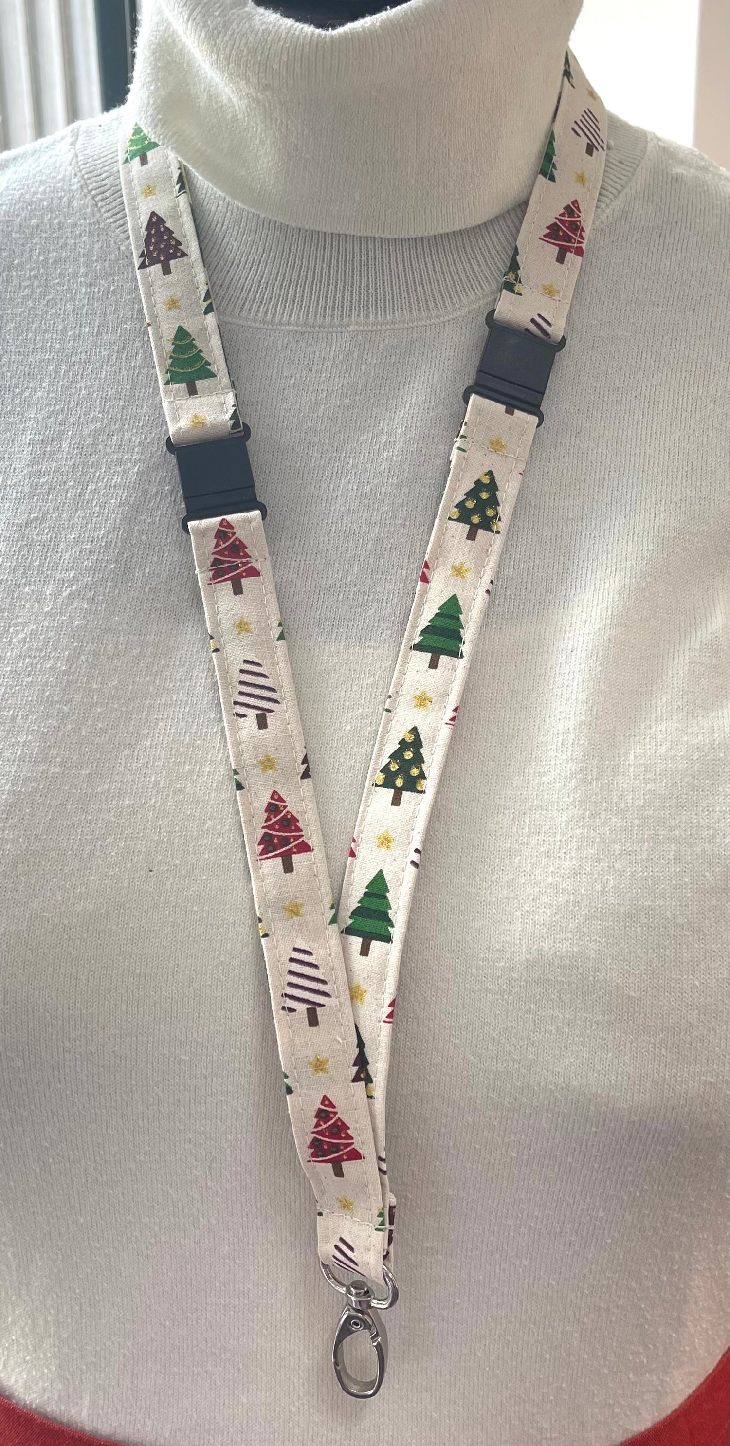 Lanyard with Christmas tree pattern worn around a neck on a mannequin.
