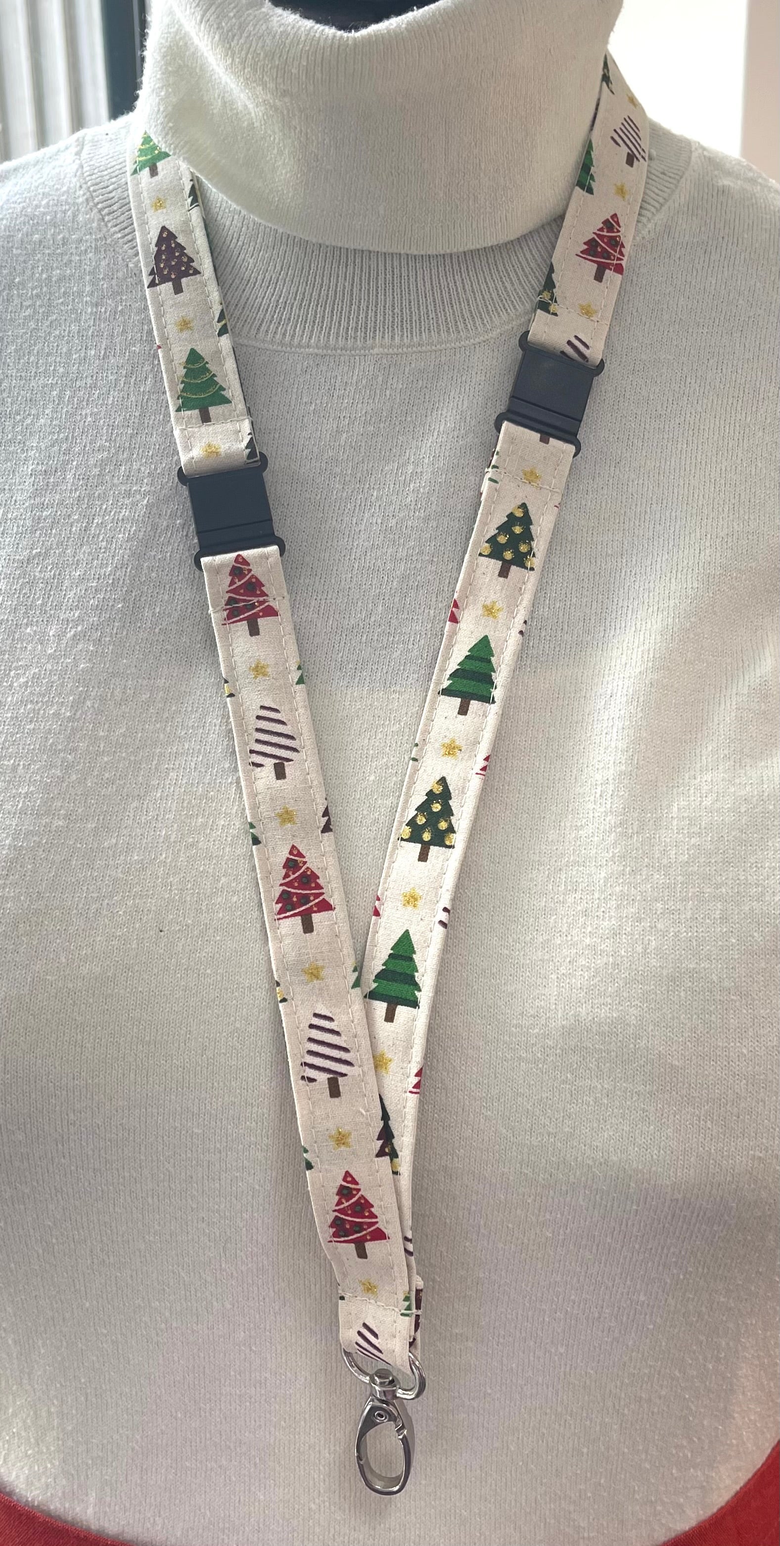 Lanyard with Christmas tree pattern worn around a neck on a mannequin.