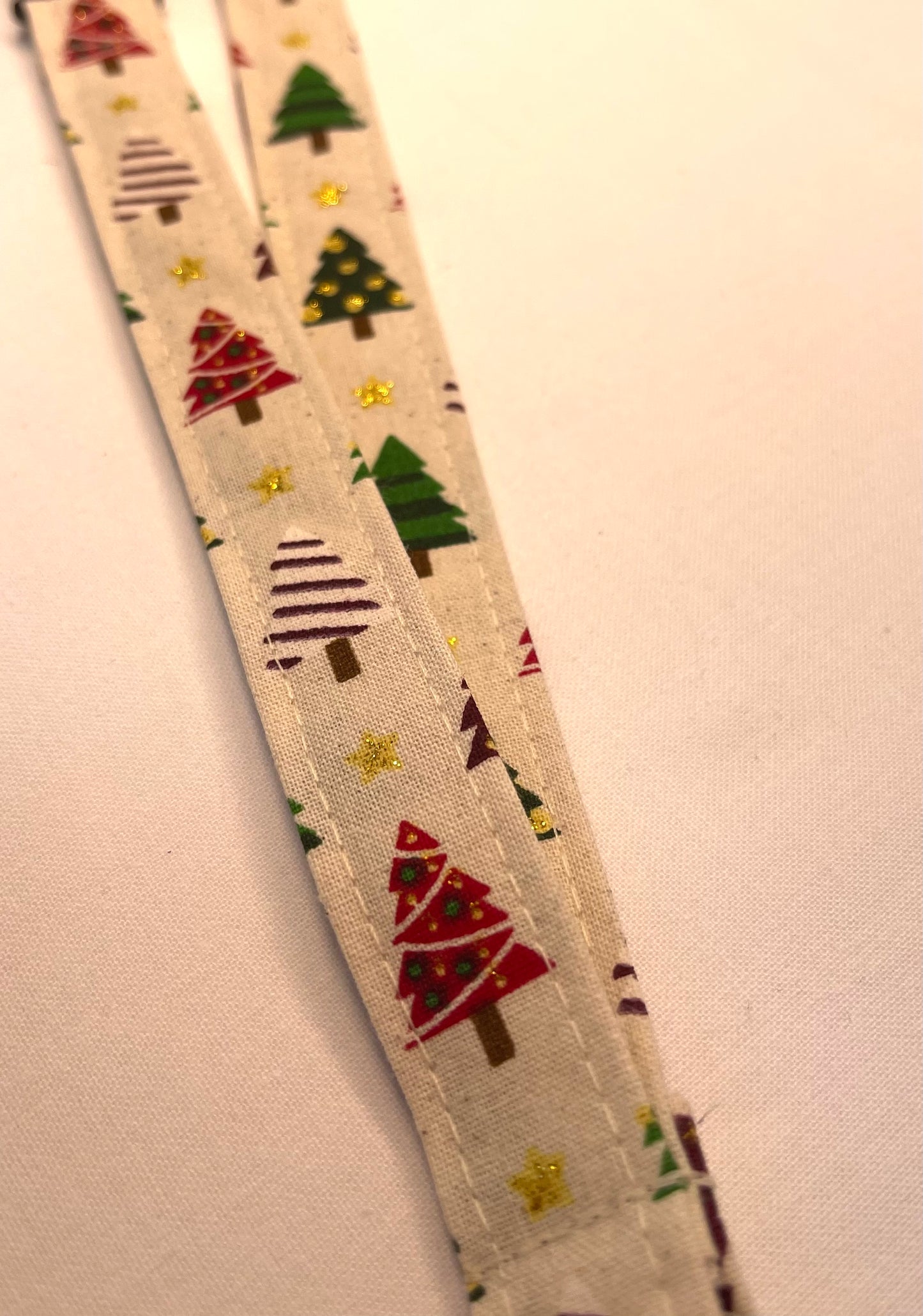 Fabric strip with Christmas tree pattern on a beige background