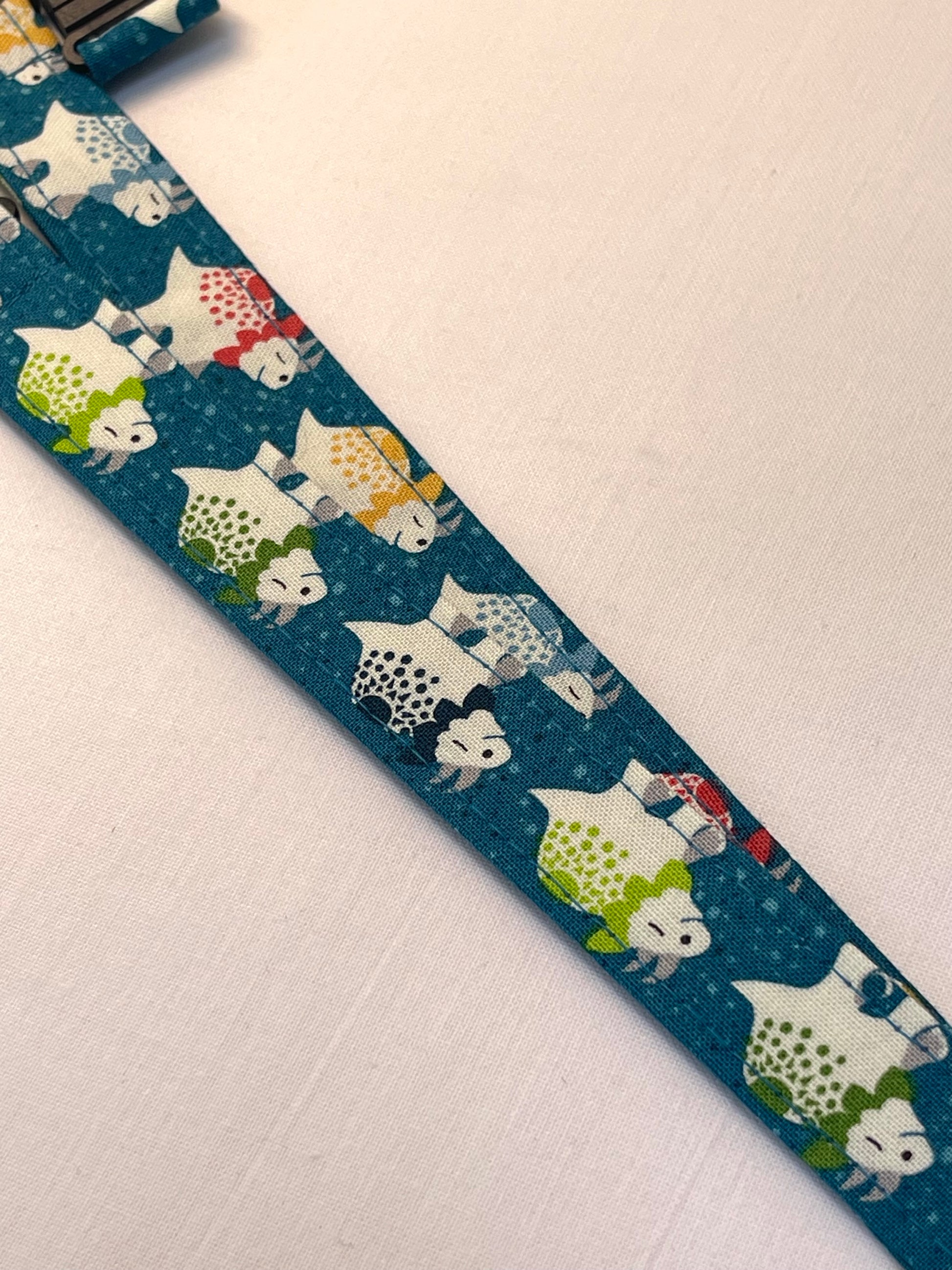 Fabric lanyards with cartoon dinosaur pattern on a blue background