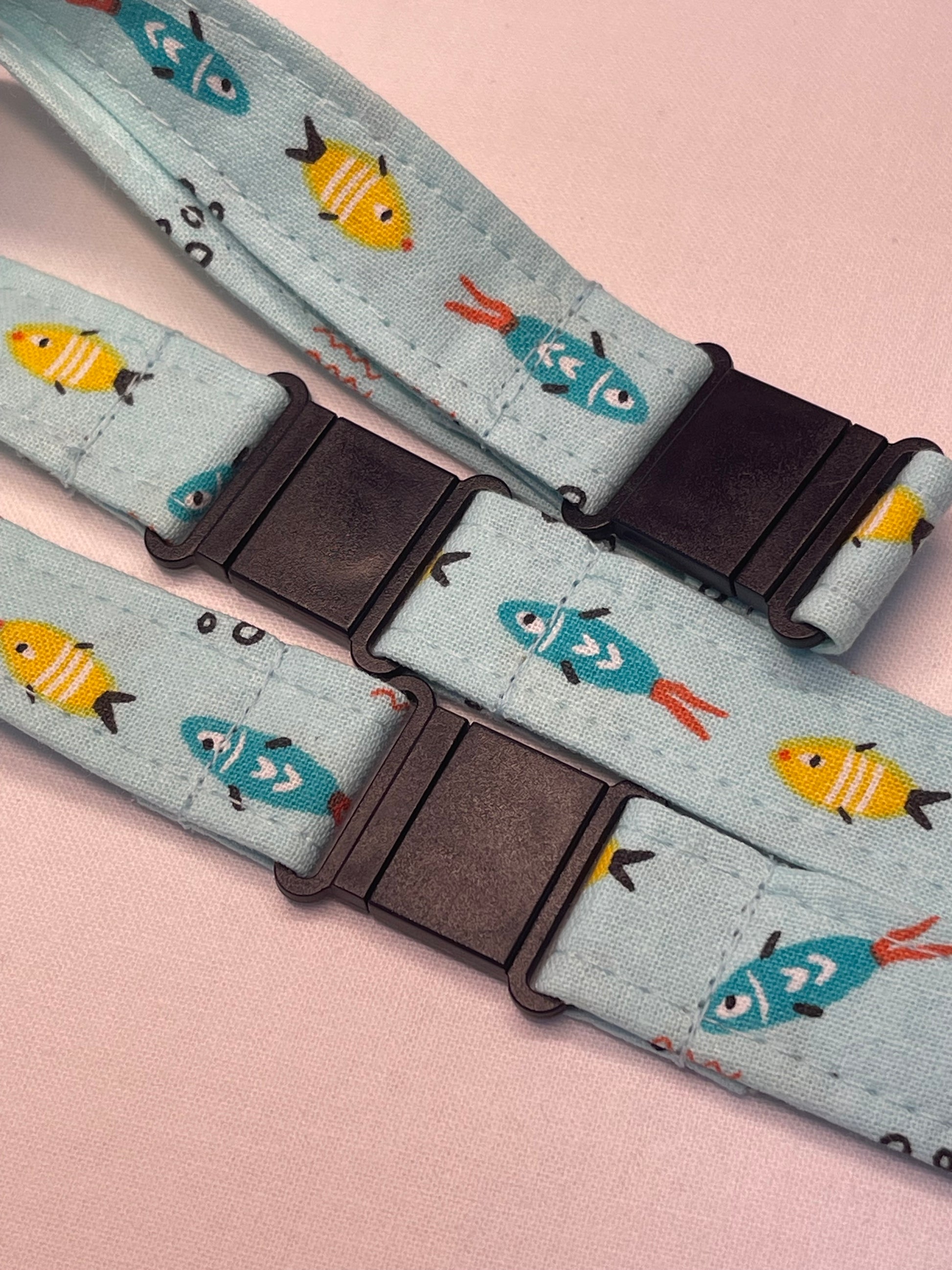 Patterned strap with fish design on a pink background