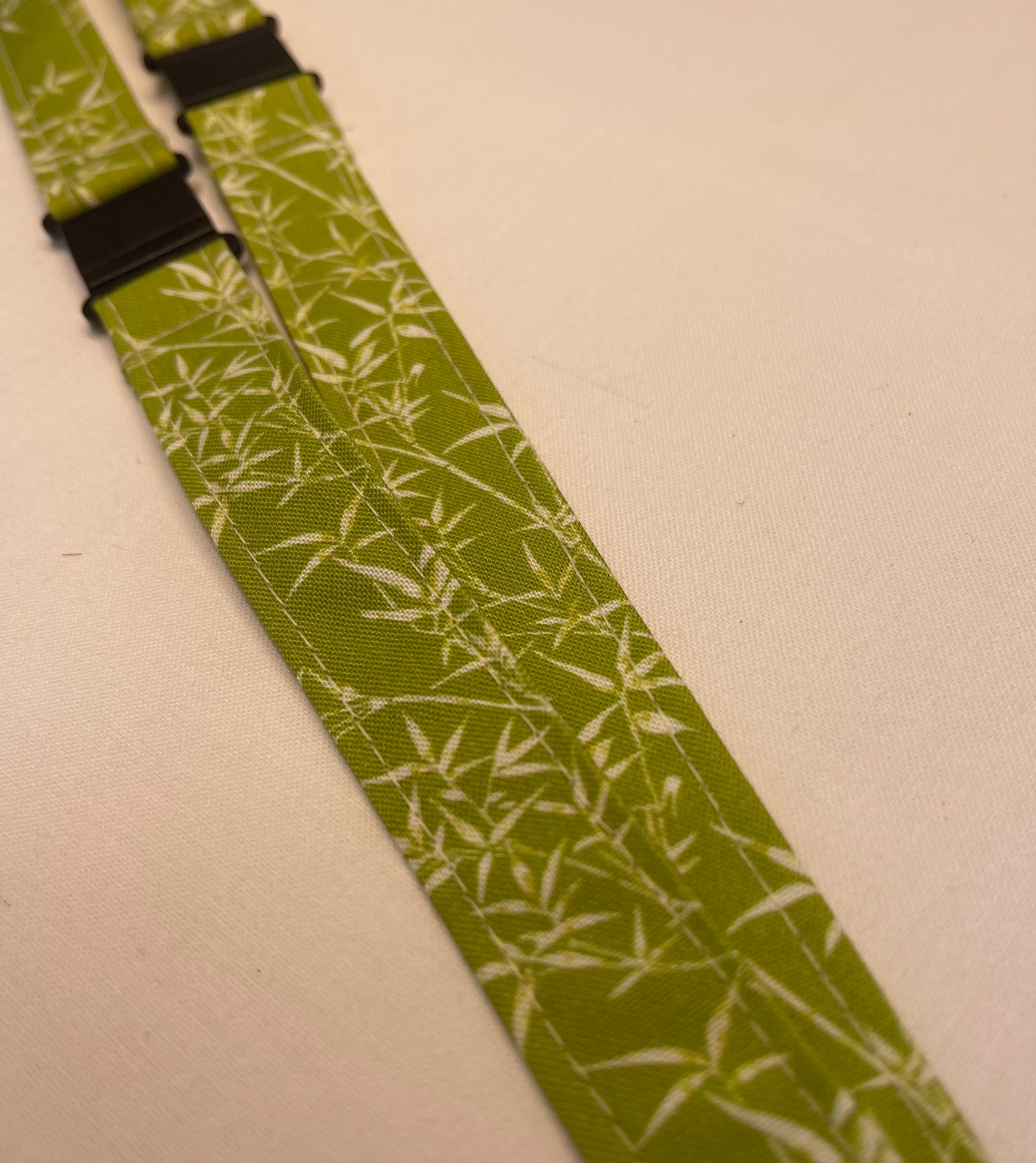 Green lanyards with white pattern on a beige background
