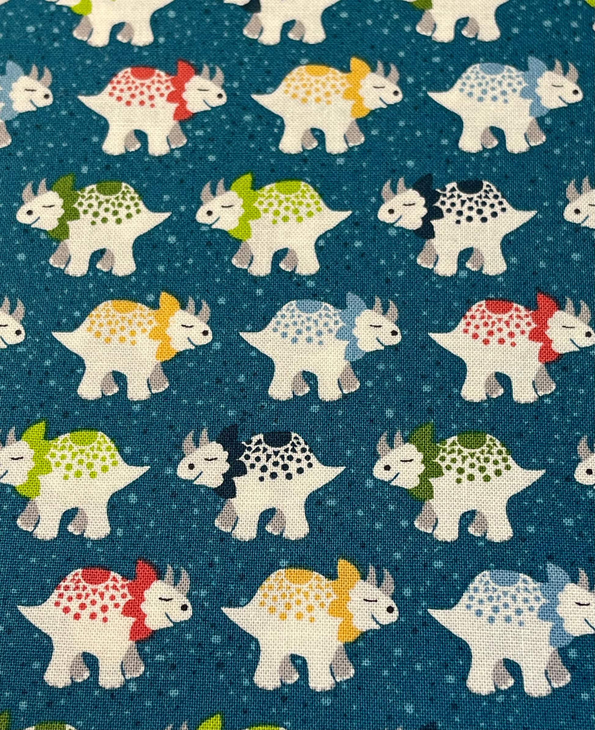 Pattern of cartoon dinosaurs on a blue background