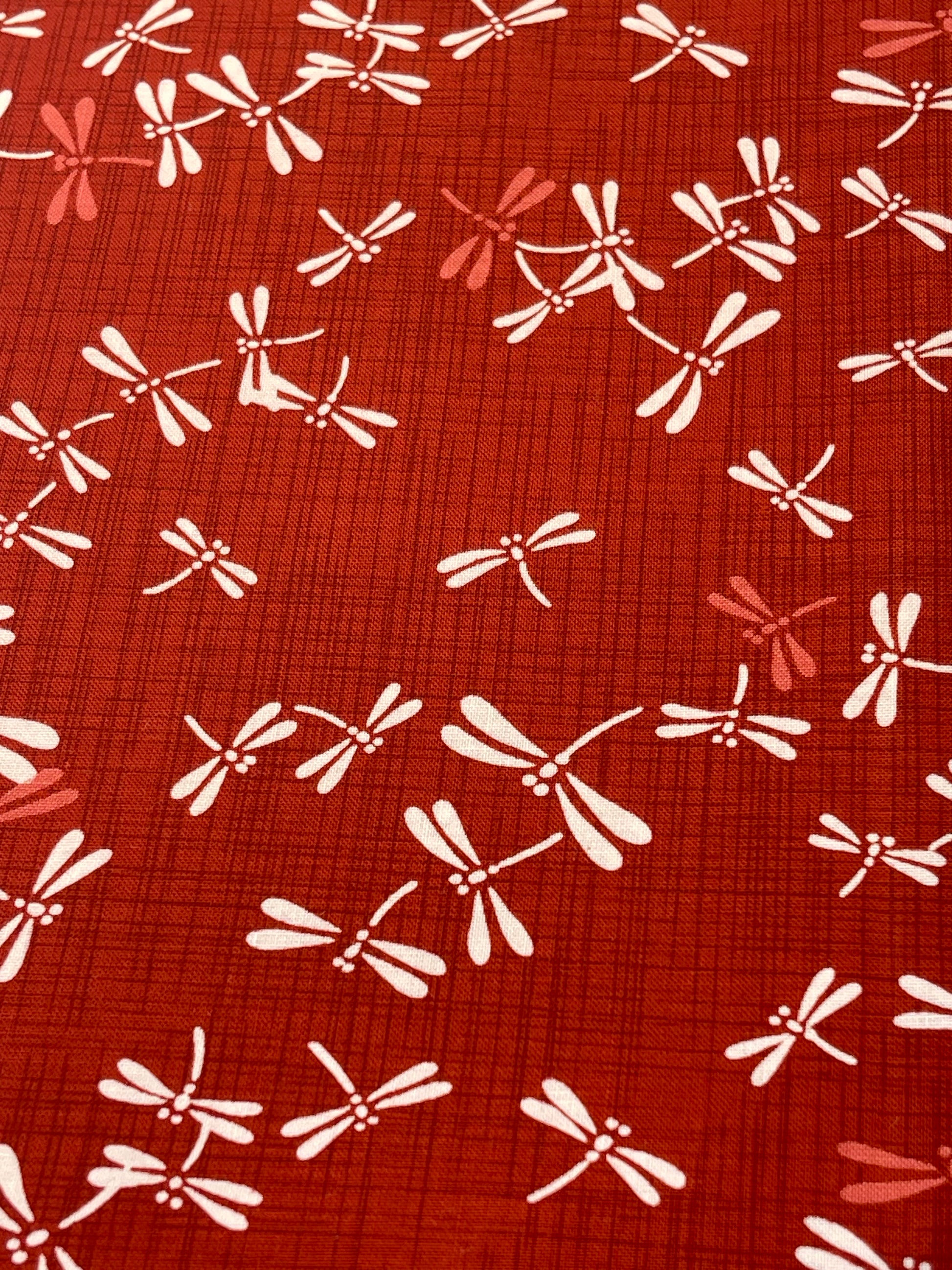 Pattern of white and red dragonflies on a red background