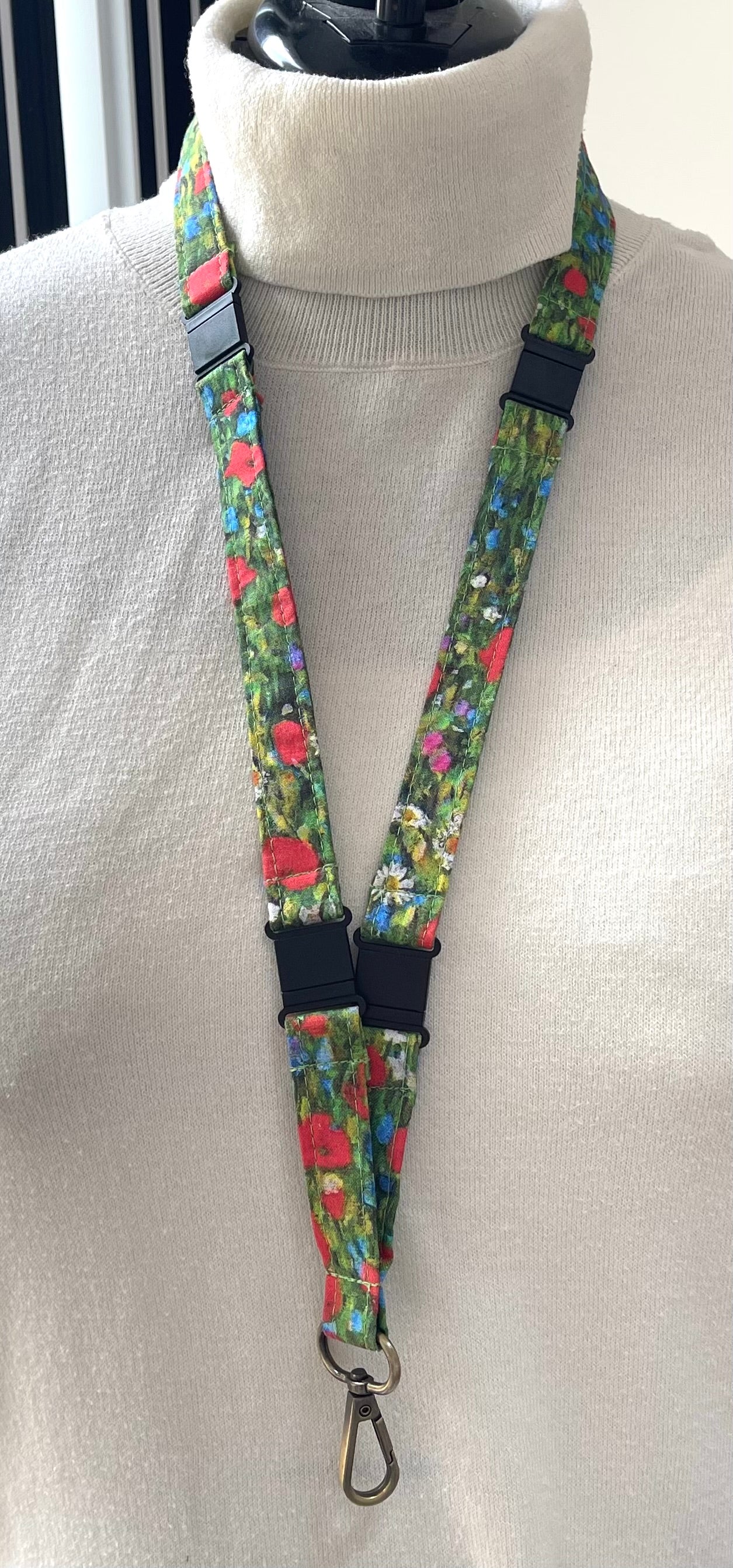Floral patterned lanyard on a mannequin with a white sweater