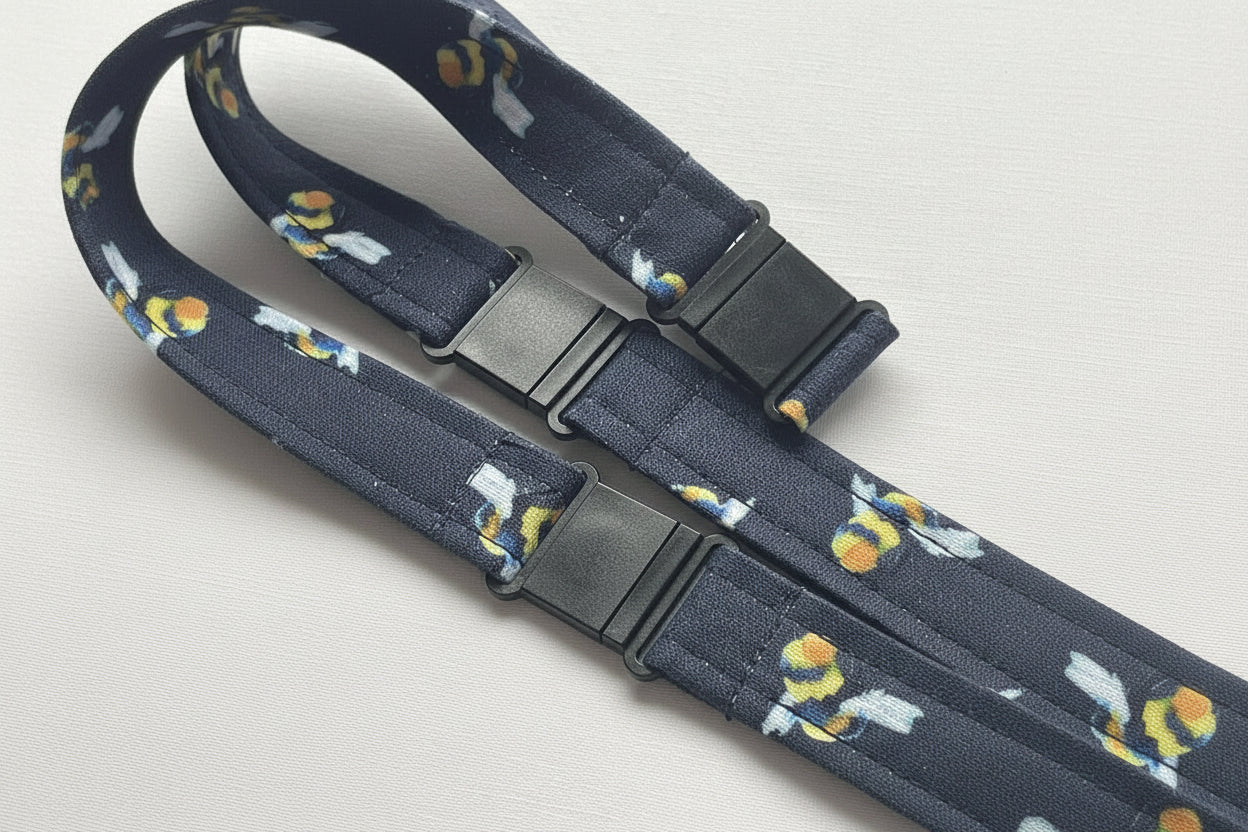 Handmade safety breakaway lanyard with multiple anti-strangulation breakaway points, designed for NHS, healthcare, mental health and security professionals. Close-up of plastic breakaway safety clip designed to release under pressure to reduce strangulation risk. 