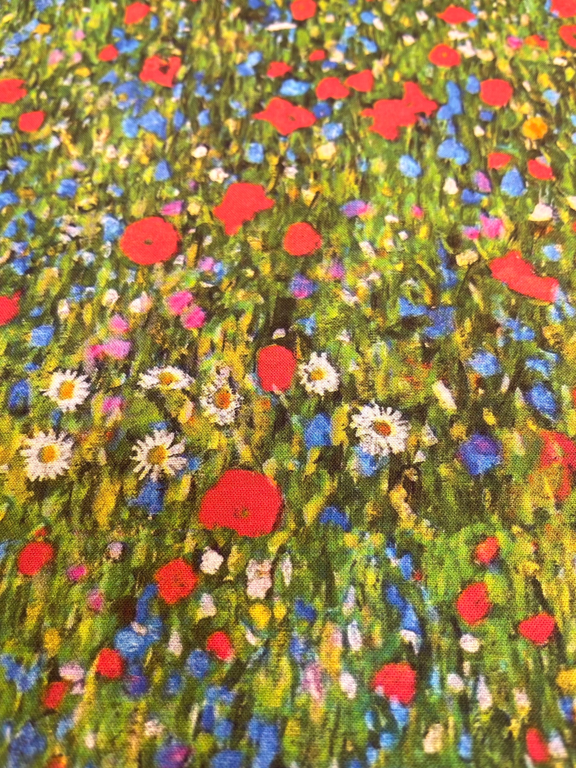 Pattern of red, blue, and white flowers on a green background