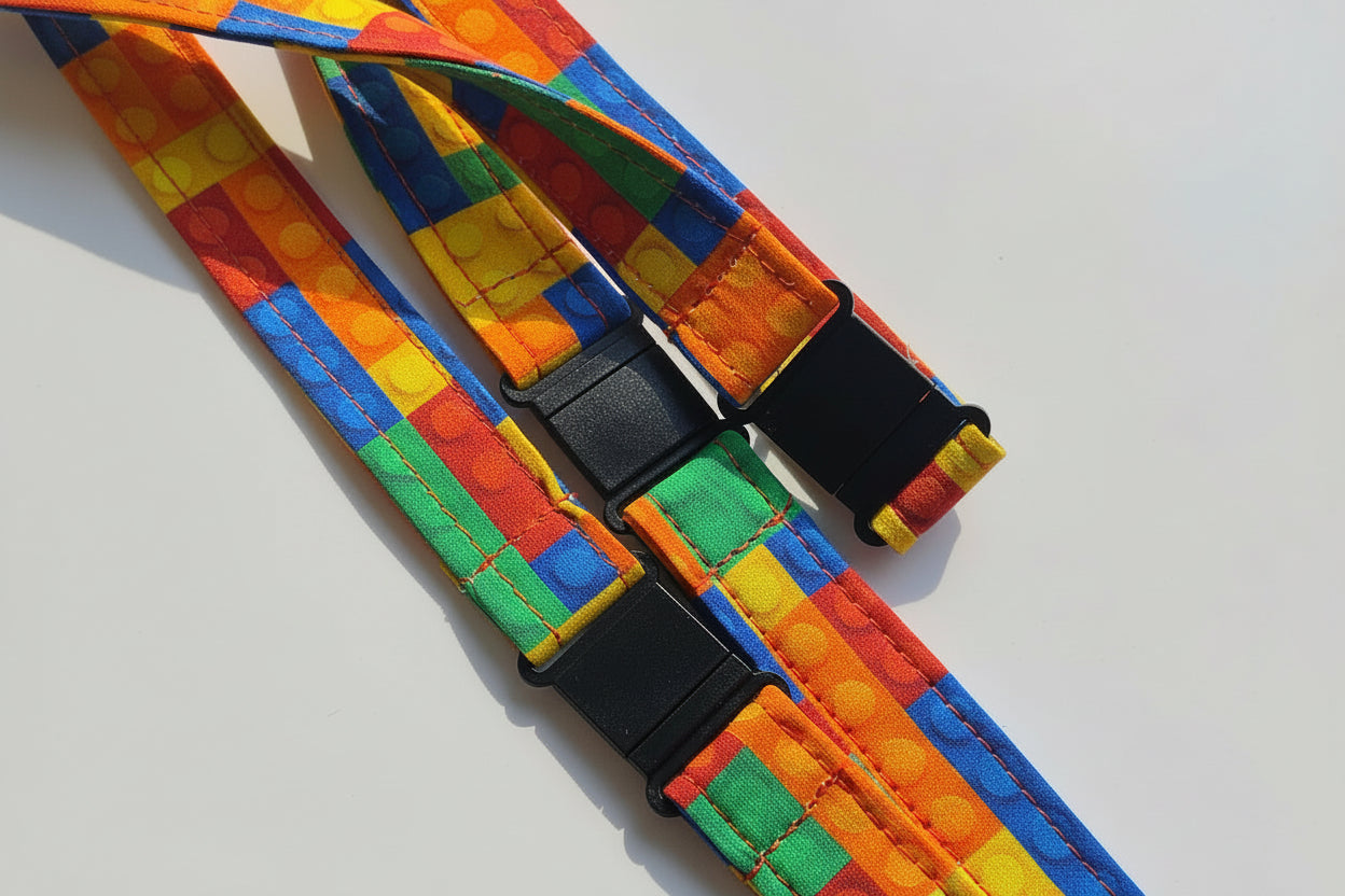 Handmade safety breakaway lanyard with multiple anti-strangulation breakaway points, designed for NHS, healthcare, mental health and security professionals. Close-up of plastic breakaway safety clip designed to release under pressure to reduce strangulation risk. 